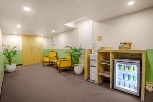 an office with a refrigerator in a room with chairs at Bloom Hotel - Karol Bagh in New Delhi