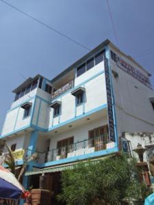 a blue and white building with a balcony at Hotel Shiva , Bodh Gaya in Bodh Gaya