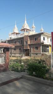 a large brick building with towers on top of it at Hotel Shiva , Bodh Gaya in Bodh Gaya