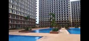 a view of two tall buildings with blue water at 1 bedroom condominium in Lapu2x in Lapu Lapu City
