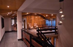 a dining room with a table and chairs in a building at Kaya Gantavya Resort in Pelling
