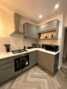 a kitchen with stainless steel cabinets and a stove at A home away from home in Manchester