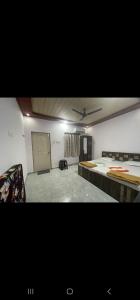 Cette chambre comprend 2 lits et une télévision. dans l'établissement Dsouza's Nature Farm, à Badlapur