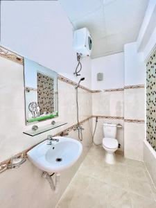 a bathroom with a sink and a toilet at Mie House Da Lat in Xuan An