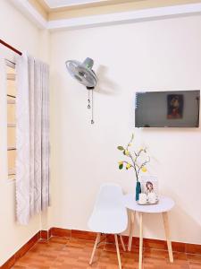 a white table and a white chair in a room at Mie House Da Lat in Xuan An