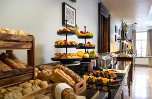 a bakery with many different types of bread and pastries at Leonardo Boutique Hotel Salzburg Gablerbräu in Salzburg