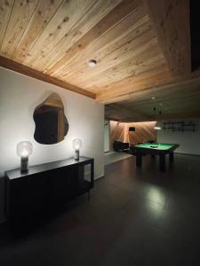 a room with a ping pong table and a couch at Hill House Apartamenty in Białka Tatrzanska