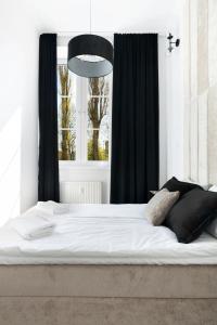 a bedroom with a large bed with a window at Old Town Premium by Elite Apartments in Gdańsk