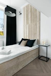 a bedroom with a large bed and a window at Old Town Premium by Elite Apartments in Gdańsk