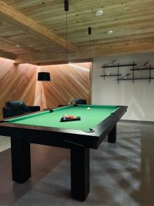 a billiard table in a room with at Hill House Apartamenty in Białka Tatrzanska