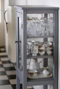 a cabinet with dishes and vases in a room at Op d'n Stolberg in Weert