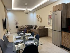 a living room with a table and a refrigerator at Central Park House - 70m² in Mohammedia