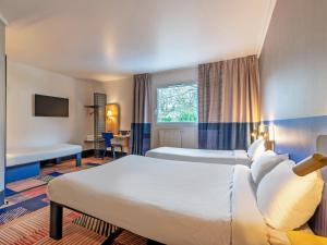 Postel nebo postele na pokoji v ubytování B&B HOTEL Brest Port du Moulin Blanc