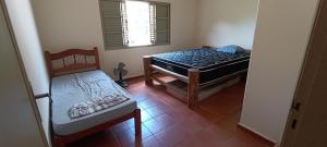 a room with a bed and a chair in it at Casa cânions Furnas in São José da Barra