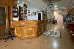 a bar in a room with a counter and chairs at Hotel O Homestay Pakmuklis Syariah 2 Near Taman Mini Lhokseumawe in Lhokseumawe