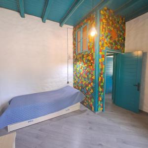 a bedroom with a bed and a wall with a door at İvanovka Boutique House in İsmayıllı