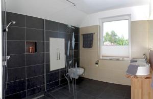 a bathroom with a shower and a sink and a toilet at Ferienwohnung Auszeit in Ueckeritz