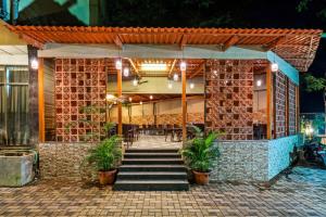 a restaurant with a brick building with potted plants at Retreat Heritage in Lonavala