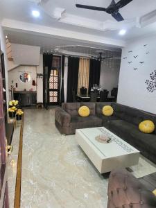 a flooded living room with a couch and a table at Luxury Ganges view Villa Homestay (Vacaow) in Rishīkesh