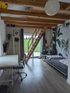 a bedroom with a bed and a desk and a staircase at Ferienhaus Seestern in Reinbek in Reinbek