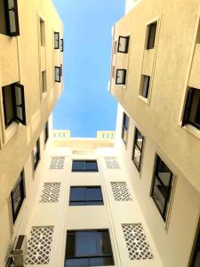 a view of a tall building looking up at the sky at Izmira Serviced Apartment Studio in Mombasa