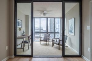 a living room with a sliding glass door with a table and chairs at Court House 1br w pool gym nr bakeries WDC-783 in Arlington