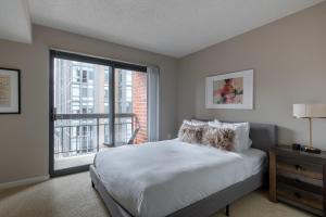 a bedroom with a bed and a large window at Court House 1br w pool gym nr bakeries WDC-783 in Arlington