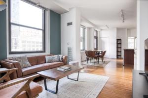 a living room with a couch and a table at Ideal Loop 2BR w Gym nr Millennium Park CHI-130 in Chicago