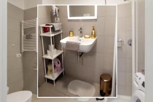 a small bathroom with a sink and a toilet at Metro Plaza Apartment -Buenos Aires in Milan