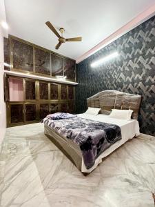 Trilok Residency - Dashashwamedh Varanasi في فاراناسي: غرفة نوم بسرير ومروحة سقف