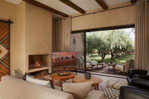 a living room with a couch and a fireplace at Villa MISH-MISH in Marrakesh