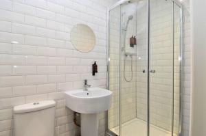 a bathroom with a toilet and a sink and a shower at The Shore in Gourock