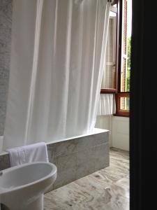 a bathroom with a white shower curtain and a sink at Hotel Olajauregi in Durango +63 photos