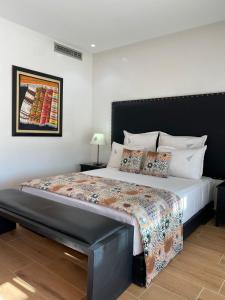 1 dormitorio con 1 cama grande y cabecero negro en Villa Firdaous, en Marrakech