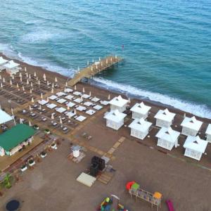 an aerial view of a beach with a pier at Iberis Hotel Lara in Altınkum
