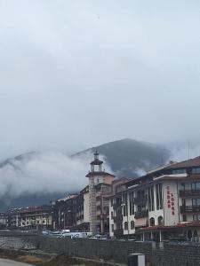 a city with a cross on top of a building at Studio in Cedar Lodge 3 in Bansko