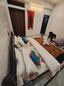 a bedroom with a large bed with pillows at Golden Marigold Hotel in Jaisalmer