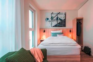 a bedroom with a large white bed and a window at Mintrops Concierge Hotel in Essen +21 photos