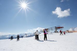 a group of people skiing on a ski slope at VALDISOLE-home in Ossana