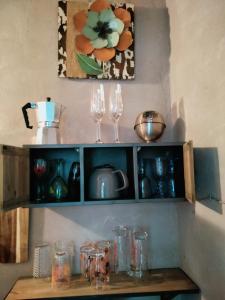 półka z kieliszkami do wina i obrazem na ścianie w obiekcie Gure Doya w mieście Billère