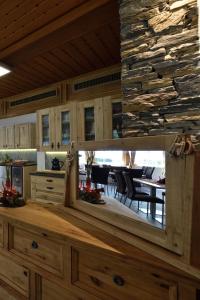 a mirror in a kitchen with a dining room at Hotel Les Mélèzes in Haudères