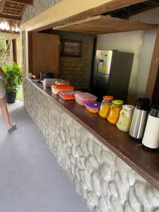 a counter with many different colored containers on it at Estrela dos Lençóis in Atins