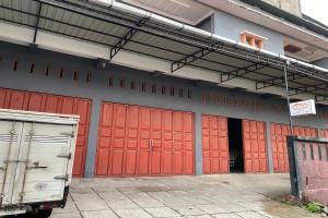 a row of red garage doors on a building at OYO 93532 Kost Nian Syariah in Parepare