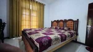 a bedroom with a bed in a room with a window at White Grand Hotel in Balangoda