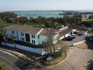 an aerial view of a house with the water in the background at The Ridge Guesthouse in Richards Bay