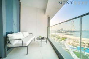a balcony with a chair and a view of the beach at Address JBR Sea View, Jumeirah Beach Residence, Dubai Marina - Mint Stay in Dubai