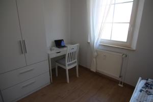 比恩多夫的住宿－Ostsseresidenz Wohnung 17，一间卧室配有一张桌子,上面有一台笔记本电脑