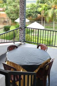 einen Tisch und Stühle auf einer Veranda mit einem Zaun in der Unterkunft Green Lake View Yala Resort in Tissamaharama