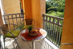 a table with a bowl of fruit on a balcony at Casa Nova, Wohnung 16 in Kühlungsborn