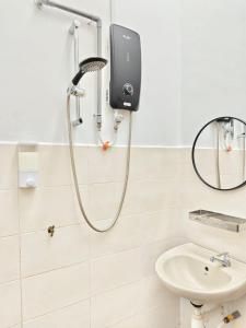 a shower in a bathroom with a sink at Homestay Temerloh Nasuha Homestay For Muslim Near Hospital with Private Pool Wi-Fi Netflix in Temerloh